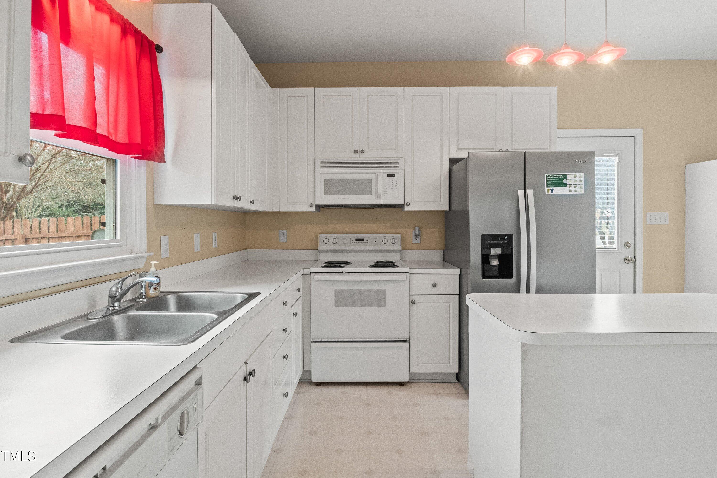 9421 Dawnshire Road Raleigh, NC 27615 - Photo 12 of 32 a kitchen with a sink stove and refrigerator