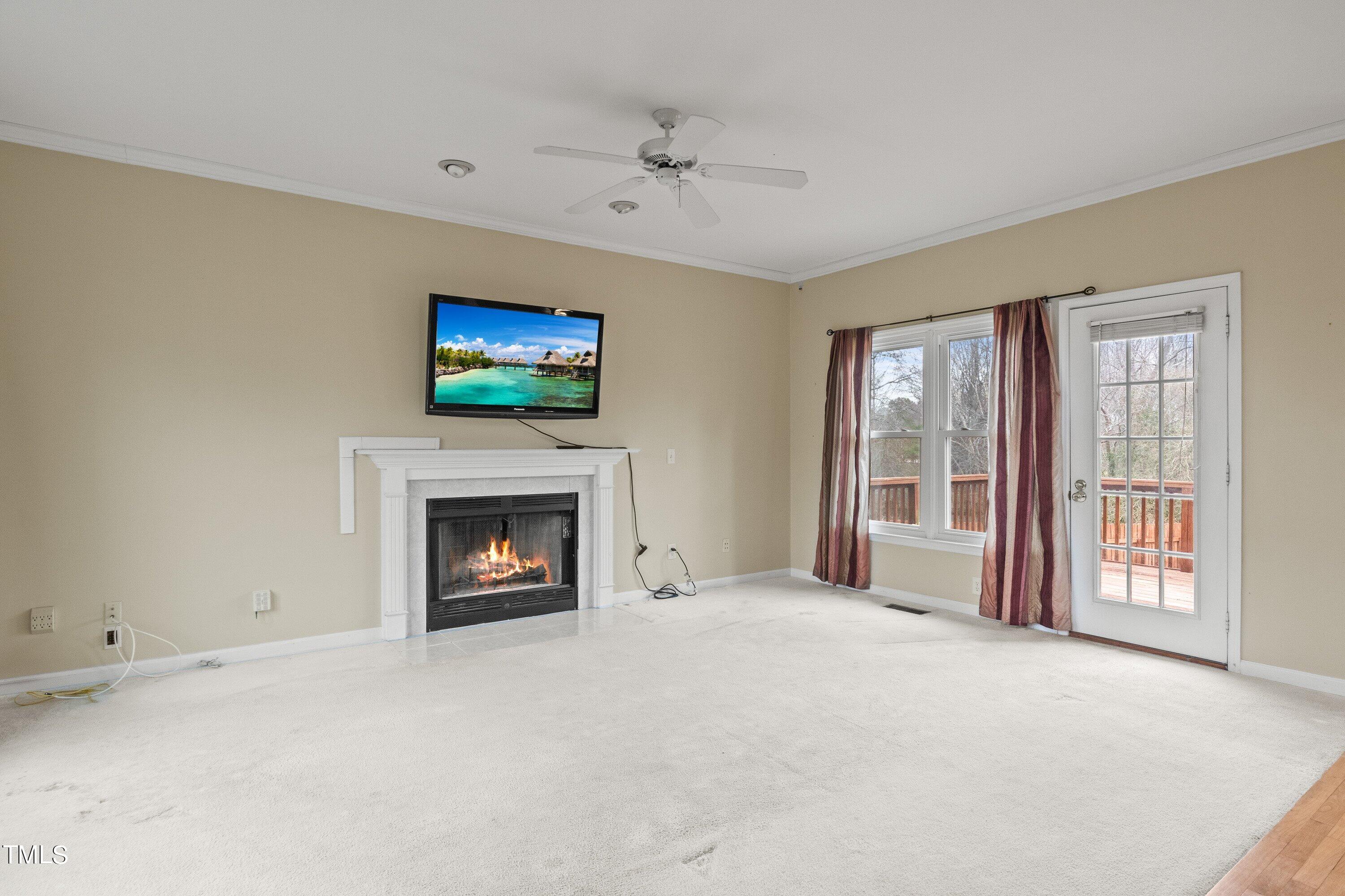 9421 Dawnshire Road Raleigh, NC 27615 - Photo 5 of 32 a view of a livingroom with a fireplace and window