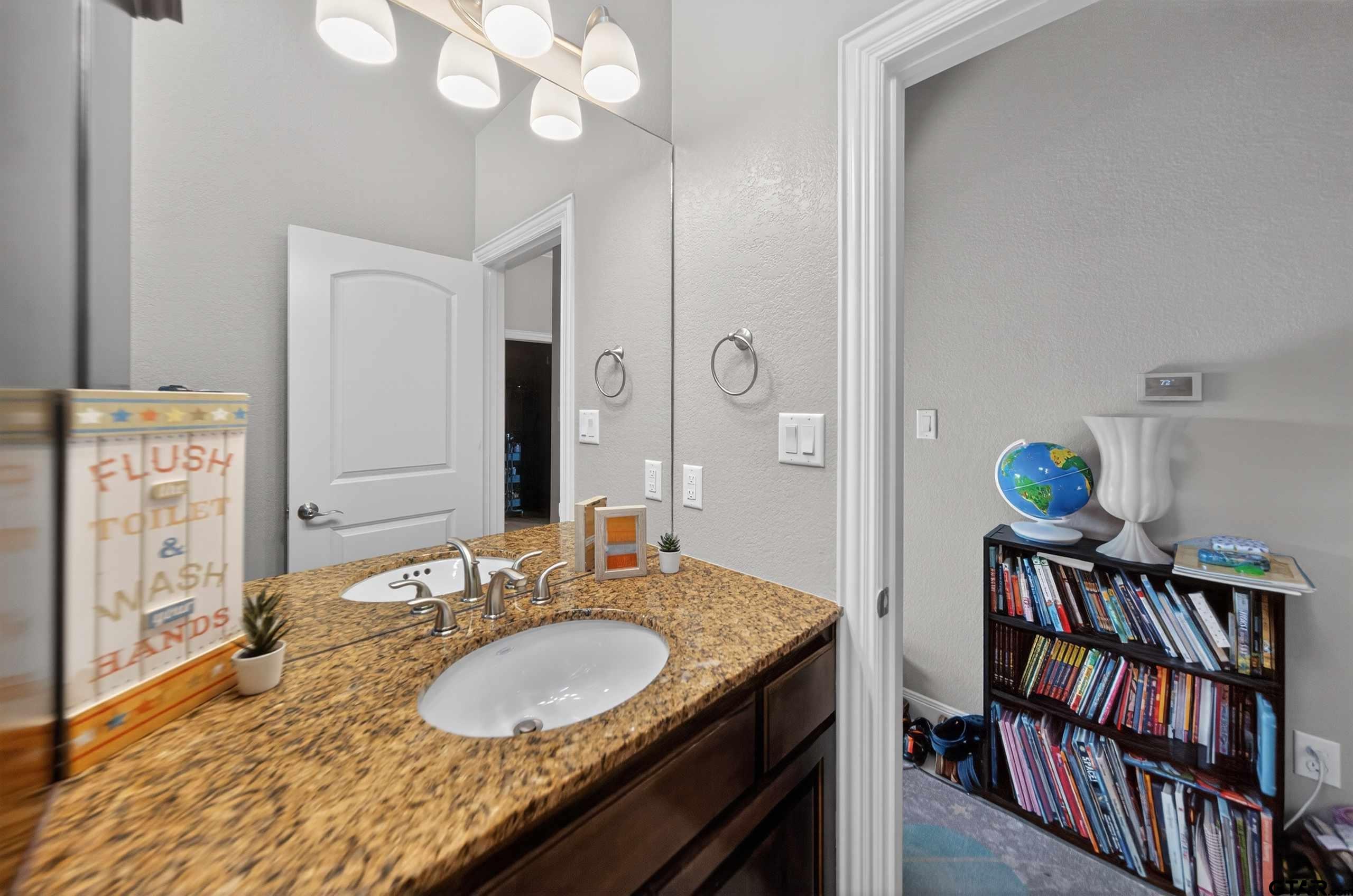 2202 Rana Park Flint, TX 75762 - Photo 44 of 47 a en suite bathroom with a granite countertop double vanity sink and a mirror