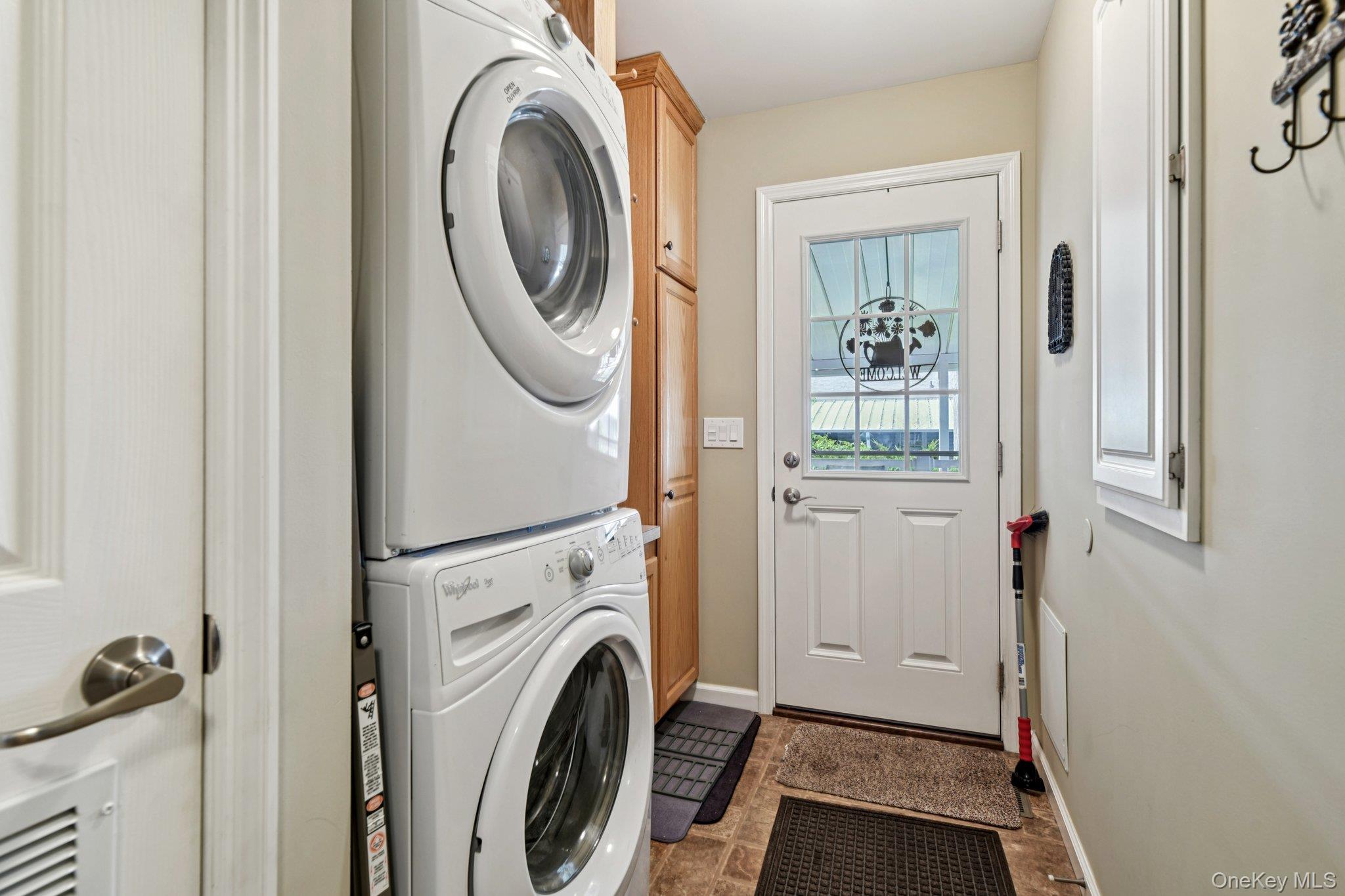 1661 Old Country Road, Unit 543 Riverhead, NY 11901 - Photo 11 of 26 Laundry area featuring stacked washer / dryer and cabinet space