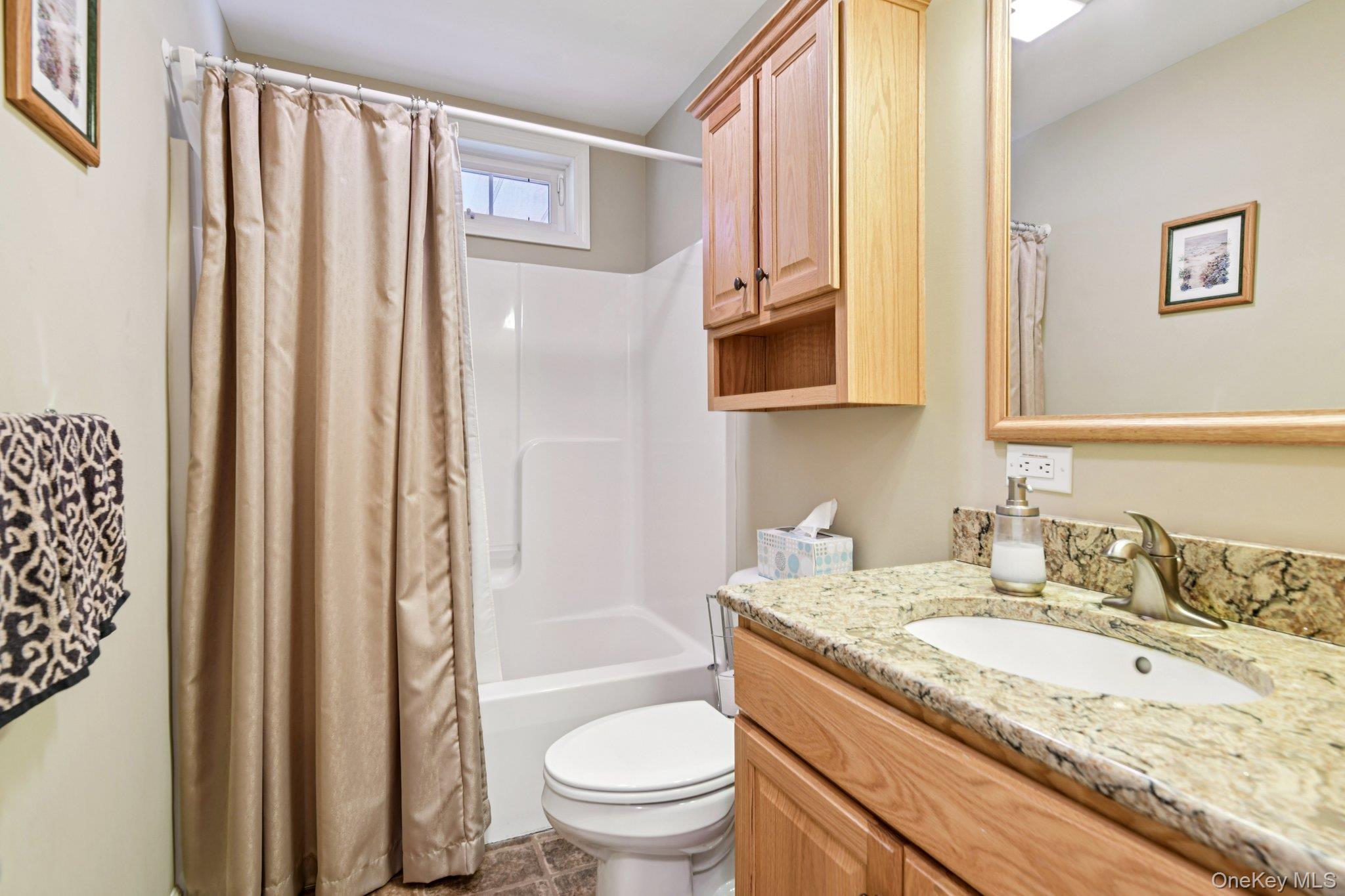 1661 Old Country Road, Unit 543 Riverhead, NY 11901 - Photo 12 of 26 Bathroom with vanity and shower / bath combination with curtain