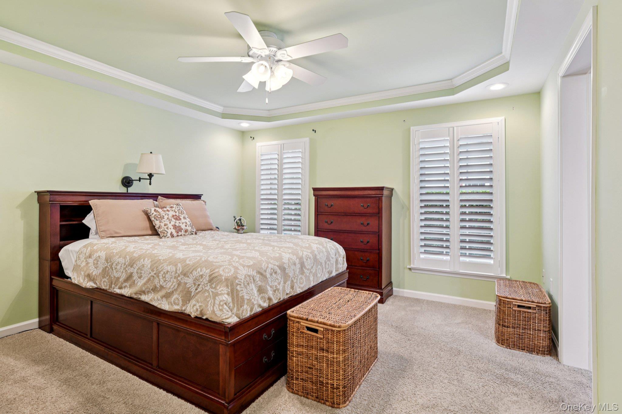 1661 Old Country Road, Unit 543 Riverhead, NY 11901 - Photo 14 of 26 Bedroom with carpet flooring, a tray ceiling, ornamental molding, recessed lighting, and ceiling fan