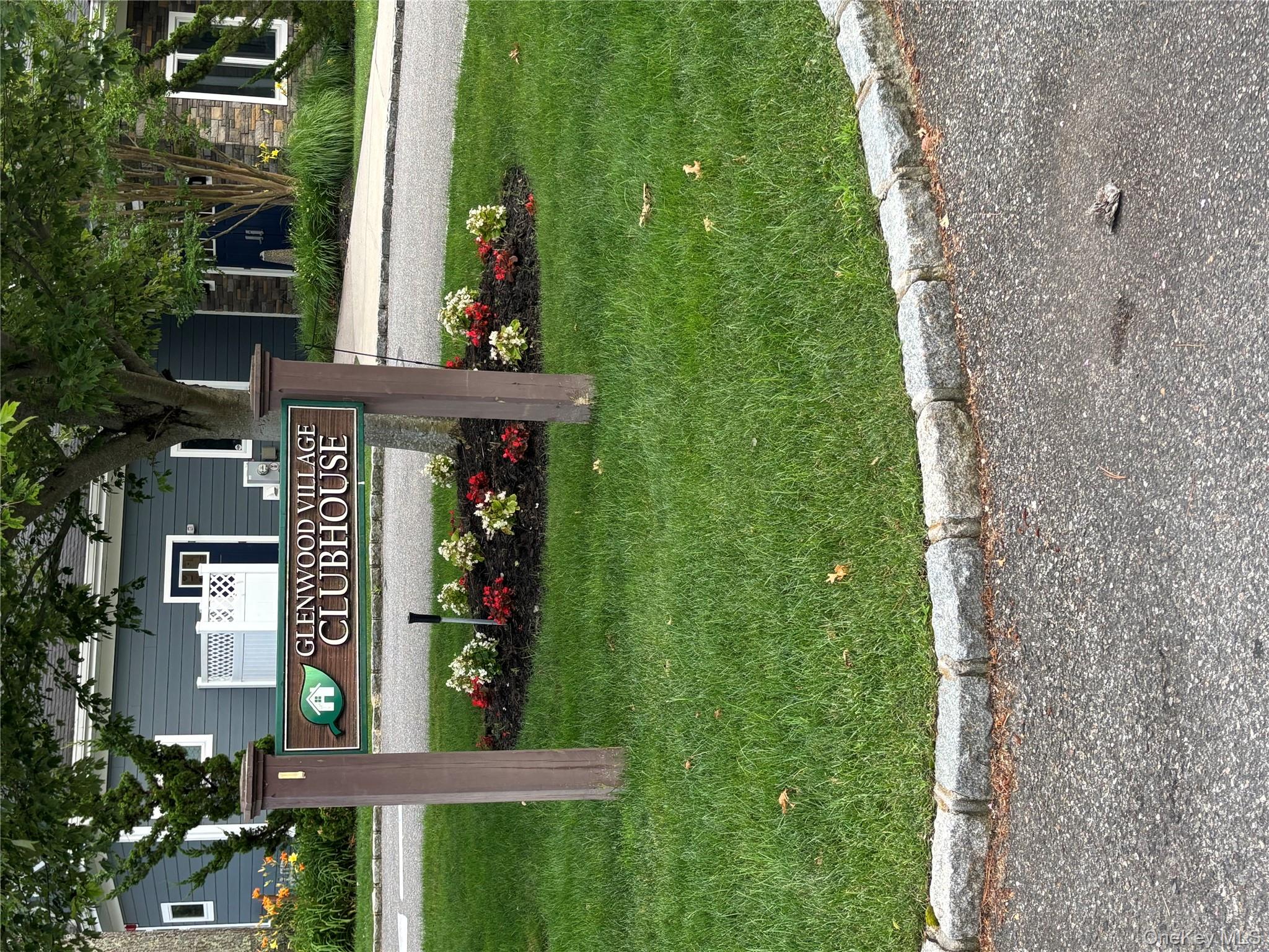 1661 Old Country Road, Unit 543 Riverhead, NY 11901 - Photo 22 of 26 Community sign with a yard