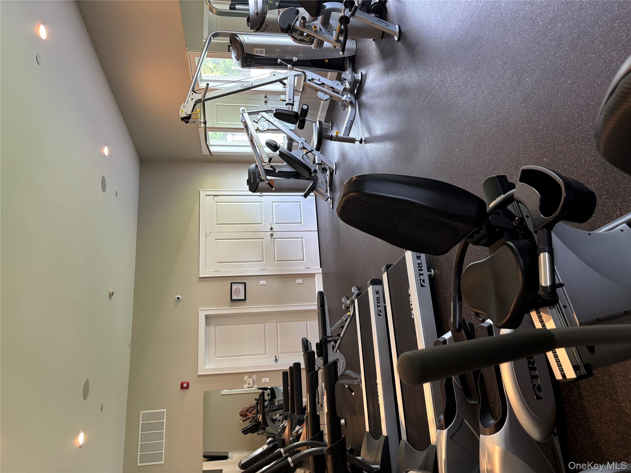1661 Old Country Road, Unit 543 Riverhead, NY 11901 - Photo 24 of 26 Workout area featuring recessed lighting