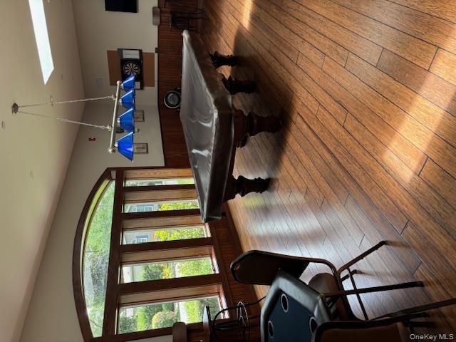 1661 Old Country Road, Unit 543 Riverhead, NY 11901 - Photo 25 of 26 Recreation room featuring wood-type flooring, a skylight, pool table, and wainscoting
