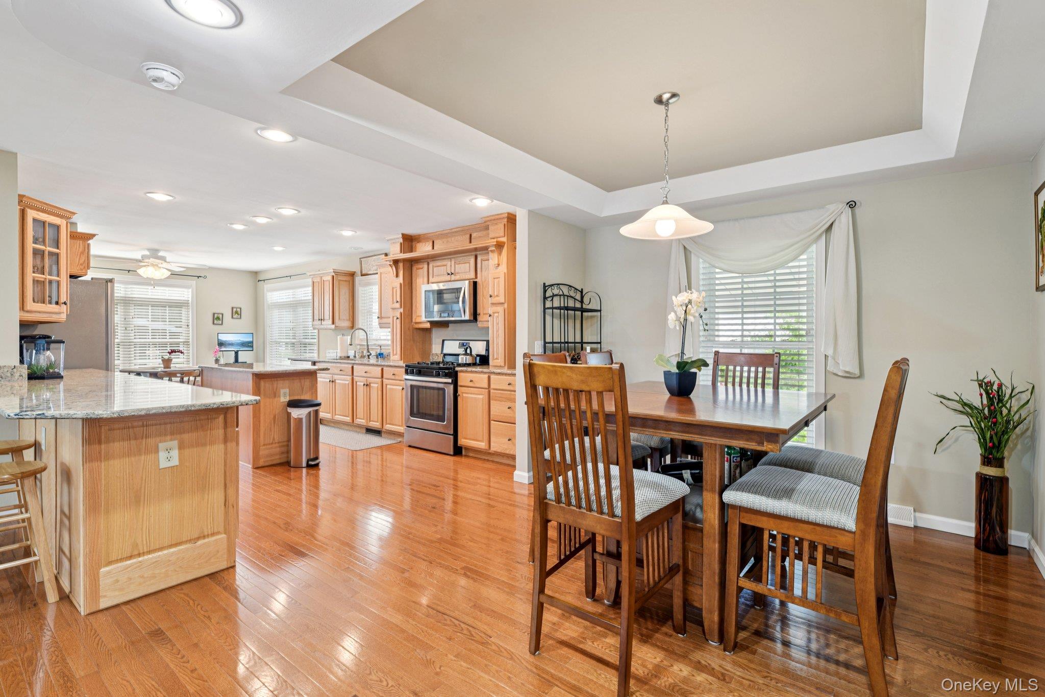 1661 Old Country Road, Unit 543 Riverhead, NY 11901 - Photo 5 of 26 Dining area with a raised ceiling, light wood-style floors, ceiling fan, and recessed lighting