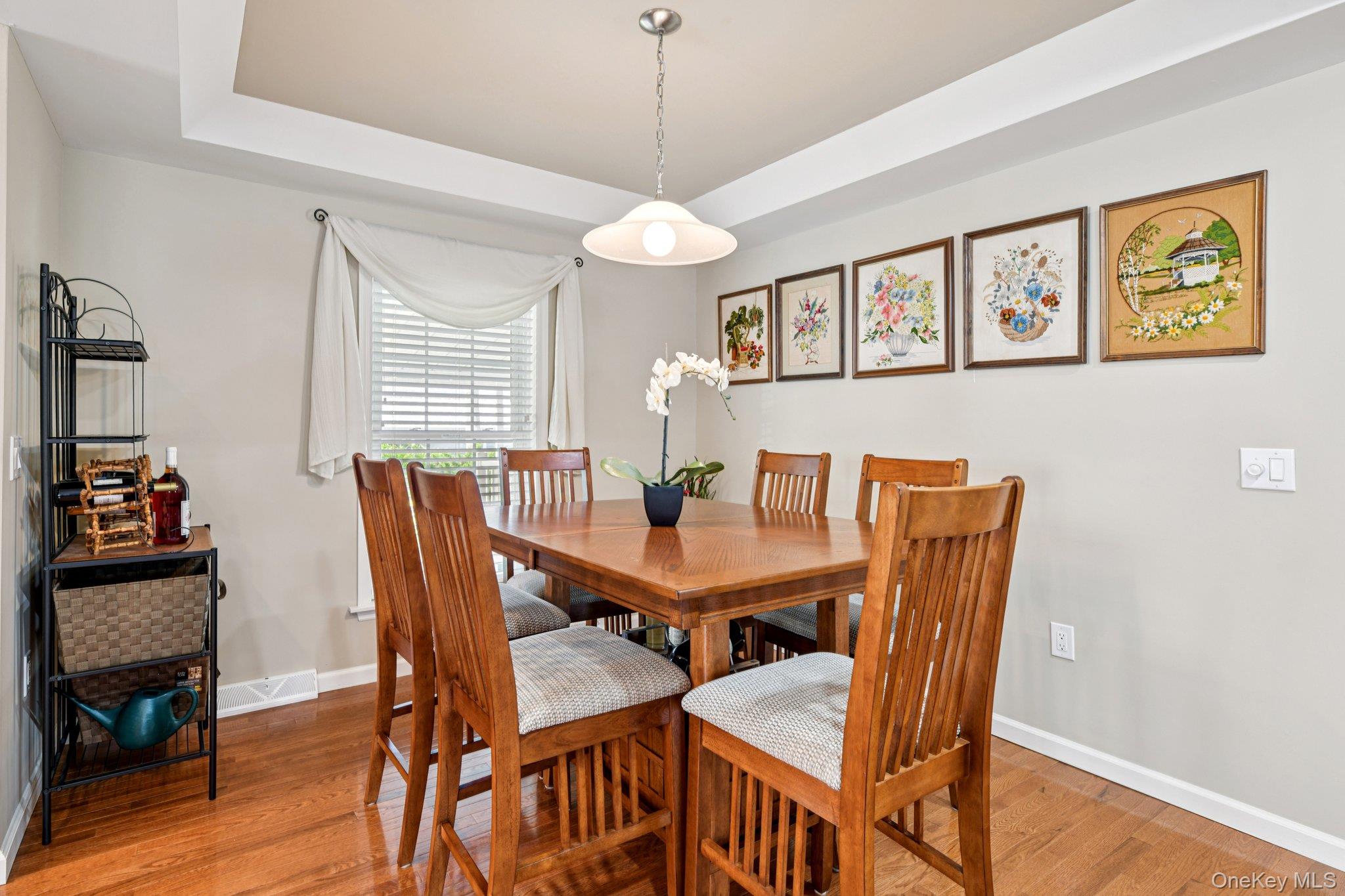 1661 Old Country Road, Unit 543 Riverhead, NY 11901 - Photo 6 of 26 Dining space with wood finished floors and a tray ceiling