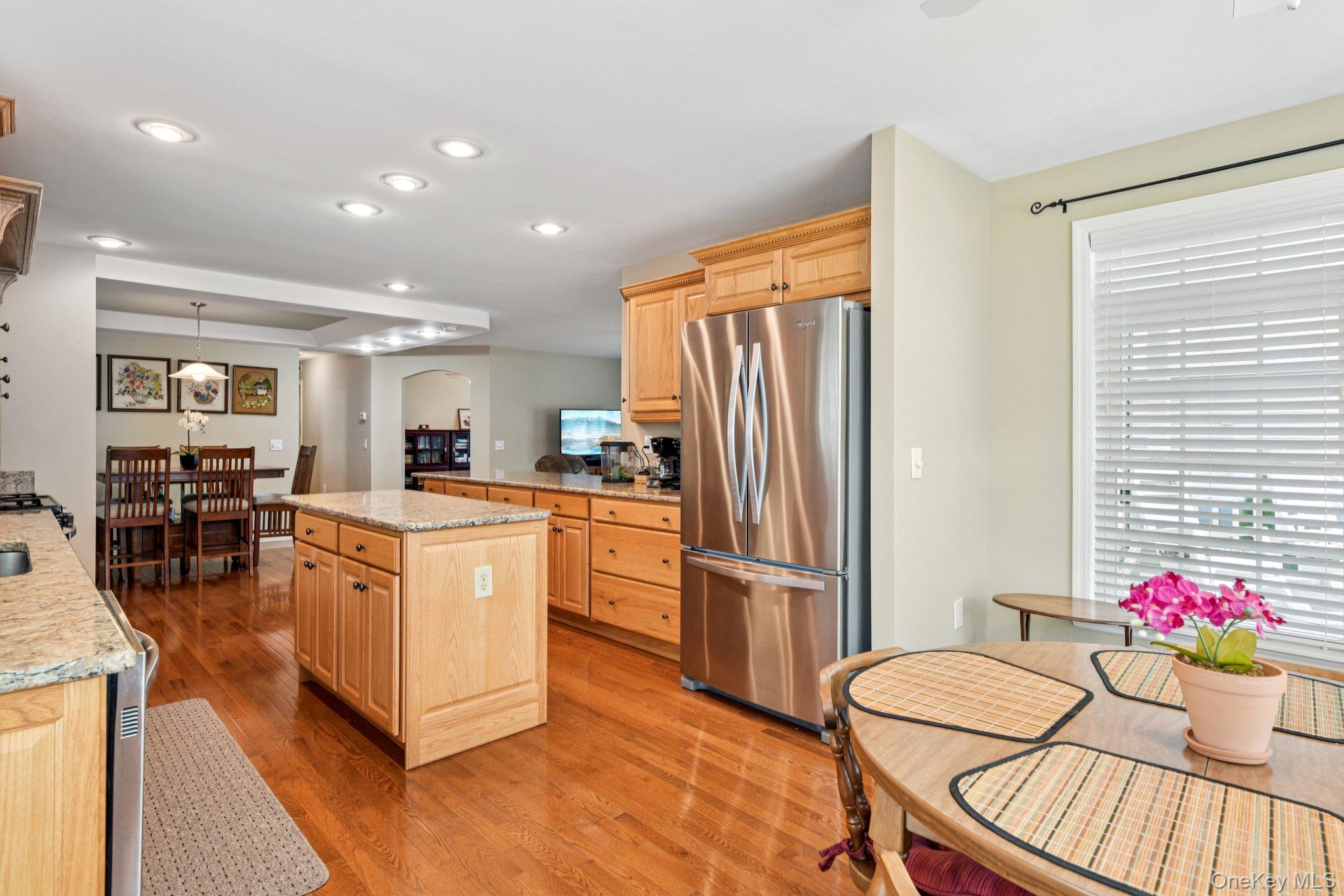 1661 Old Country Road, Unit 543 Riverhead, NY 11901 - Photo 7 of 26 Kitchen featuring freestanding refrigerator, light brown cabinets, arched walkways, light wood-type flooring, and recessed lighting
