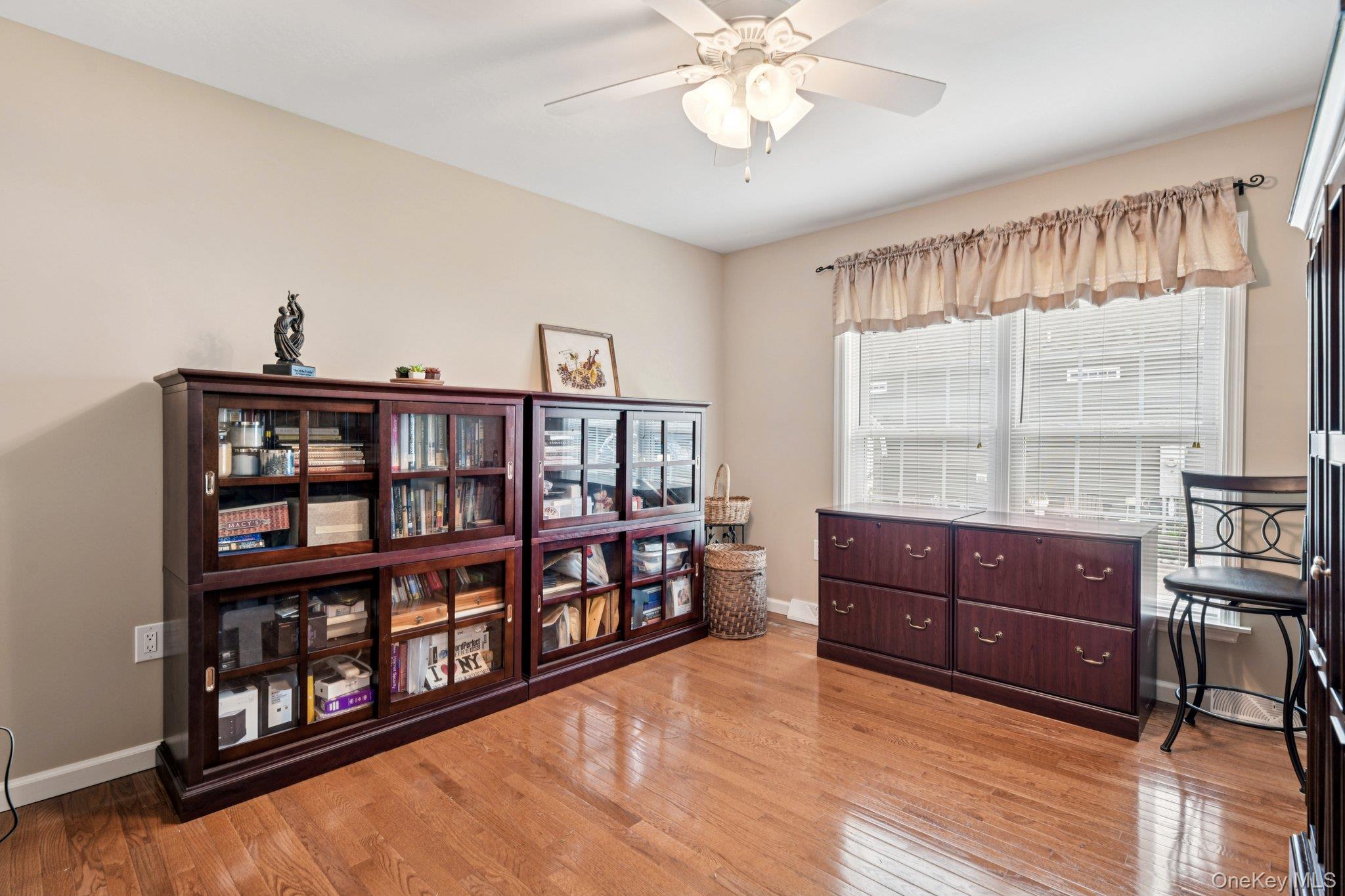 1661 Old Country Road, Unit 543 Riverhead, NY 11901 - Photo 10 of 26 Living area featuring a ceiling fan and light wood finished floors