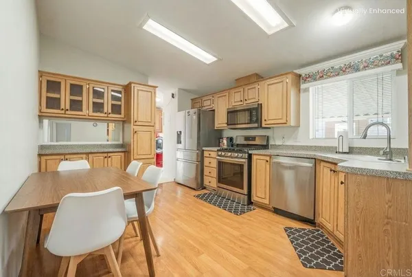 a kitchen with stainless steel appliances kitchen island granite countertop a sink and cabinets