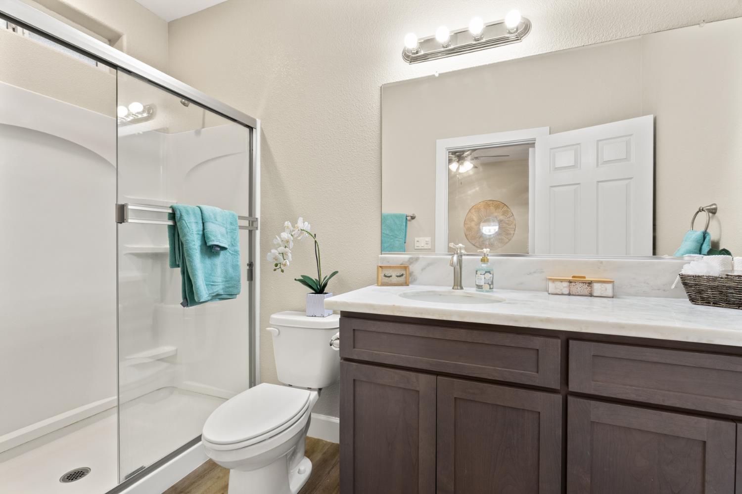 2985 1st Street Biggs, CA 95917 - Photo 13 of 18 a bathroom with a granite countertop sink toilet and shower