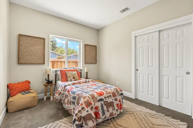 a bedroom with a bed and a window