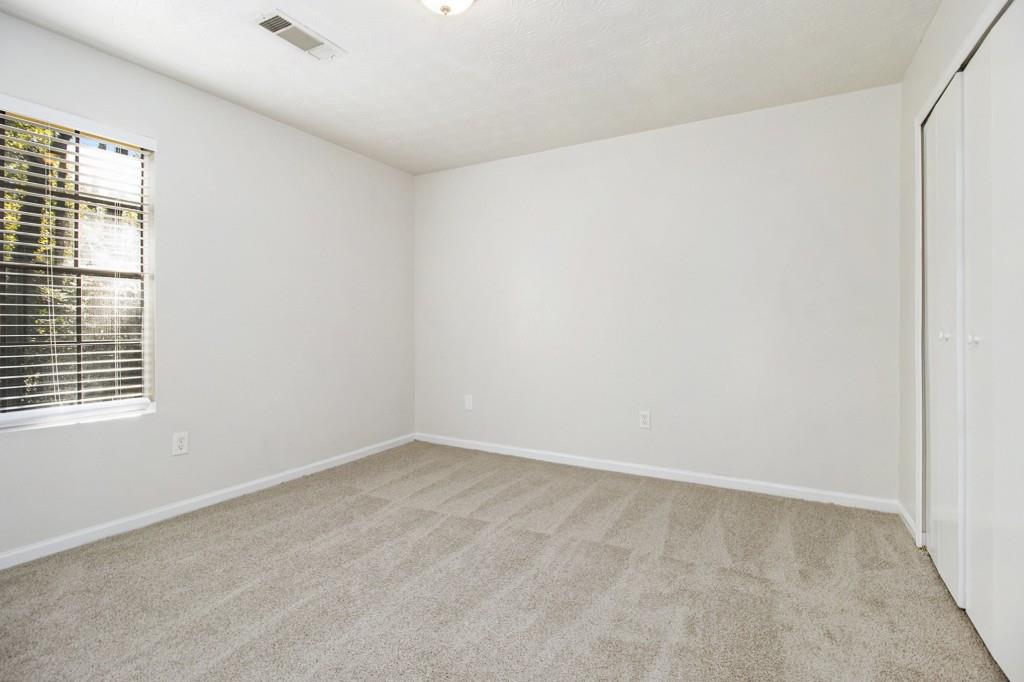 5774 Taffeta Court Lithonia, GA 30058 - Photo 11 of 25 an empty room with a window