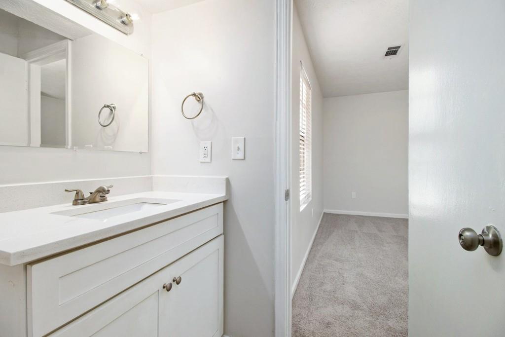 5774 Taffeta Court Lithonia, GA 30058 - Photo 15 of 25 a bathroom with a sink vanity granite tub and a mirror