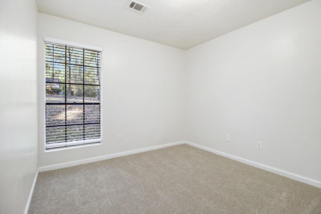 5774 Taffeta Court Lithonia, GA 30058 - Photo 20 of 25 an empty room with windows
