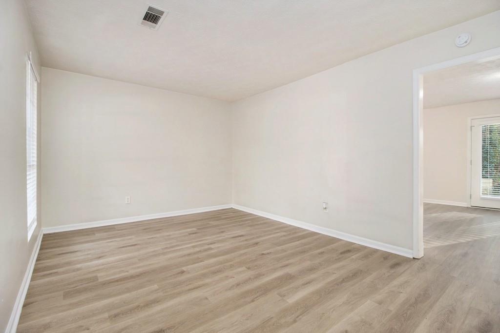 5774 Taffeta Court Lithonia, GA 30058 - Photo 2 of 25 an empty room with wooden floor
