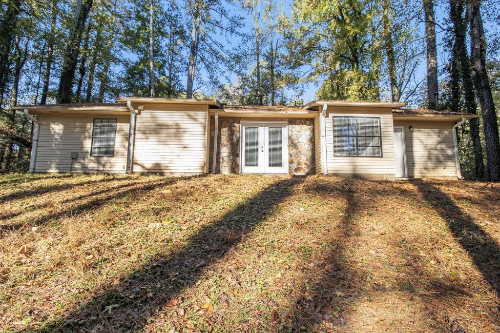 5774 Taffeta Court Lithonia, GA 30058 - Photo 24 of 25 a view of a house with a yard covered with snow and trees
