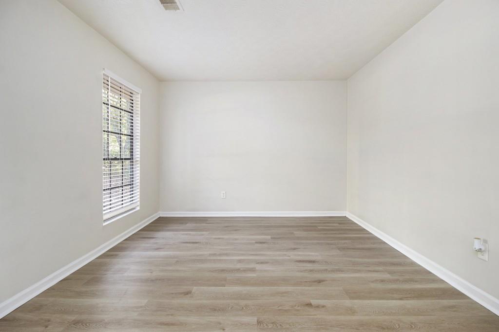 5774 Taffeta Court Lithonia, GA 30058 - Photo 3 of 25 a view of an empty room with wooden floor and window