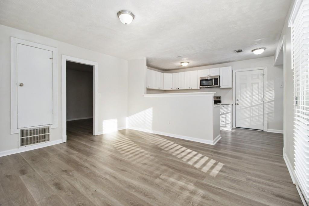 5774 Taffeta Court Lithonia, GA 30058 - Photo 6 of 25 a view of a kitchen with wooden floor