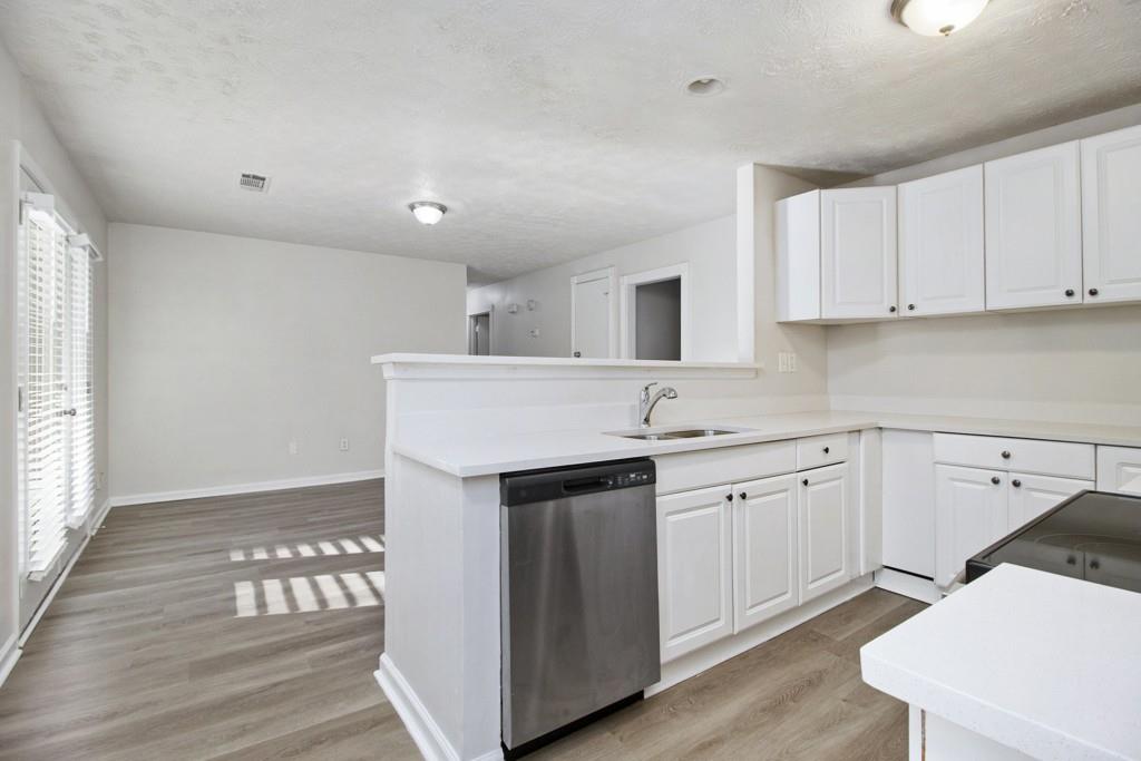 5774 Taffeta Court Lithonia, GA 30058 - Photo 8 of 25 a kitchen with granite countertop white cabinets and white appliances