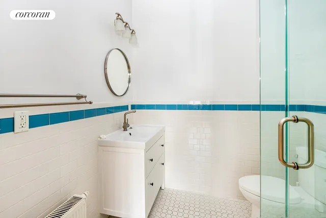 a bathroom with a sink vanity and toilet