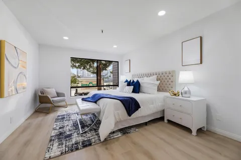 a spacious bedroom with a large bed and a couch
