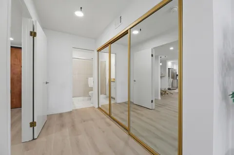 a bathroom with a granite countertop sink a mirror and shower