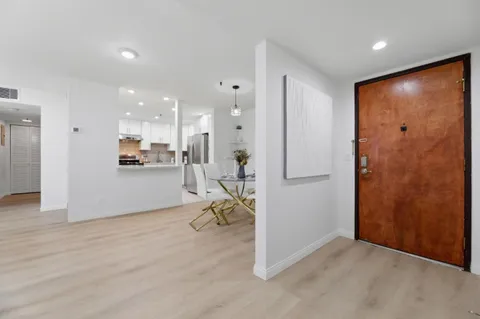 a view of a livingroom with furniture and a refrigerator