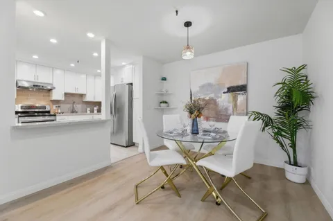 a kitchen with a table and chairs in it