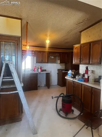 a kitchen with stainless steel appliances kitchen island granite countertop a sink dishwasher stove and cabinets