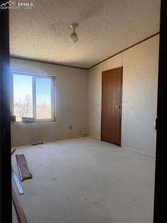 an empty room with windows and closet