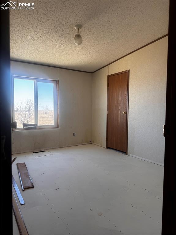 4150 Sengbeil Road Yoder, CO 80864 - Photo 4 of 9 an empty room with windows and closet