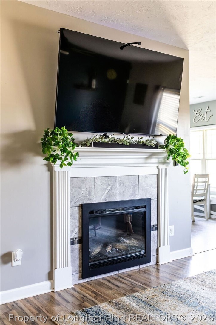 210 McGougan Road Lumber Bridge, NC 28357 - Photo 21 of 47 a living room with a fireplace and a potted plant