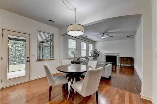 a view of a dining room with furniture wooden floor and chandelier