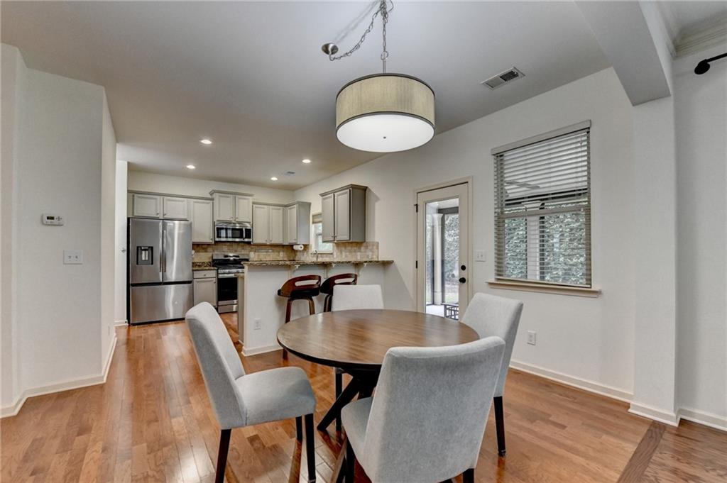 5013 Groover Drive Smyrna, GA 30080 - Photo 15 of 70 a view of a dining room with furniture wooden floor and chandelier