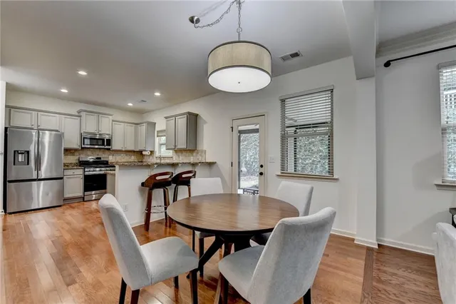 a kitchen with stainless steel appliances granite countertop a stove and a sink