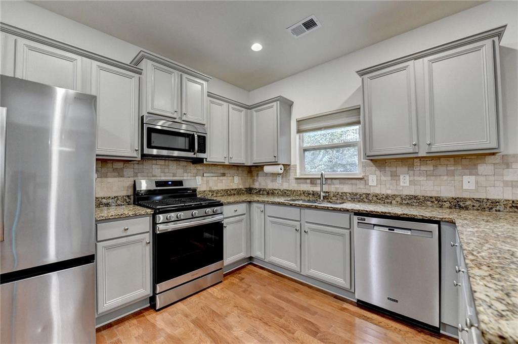 5013 Groover Drive Smyrna, GA 30080 - Photo 18 of 70 a kitchen with stainless steel appliances granite countertop a stove a sink and a refrigerator