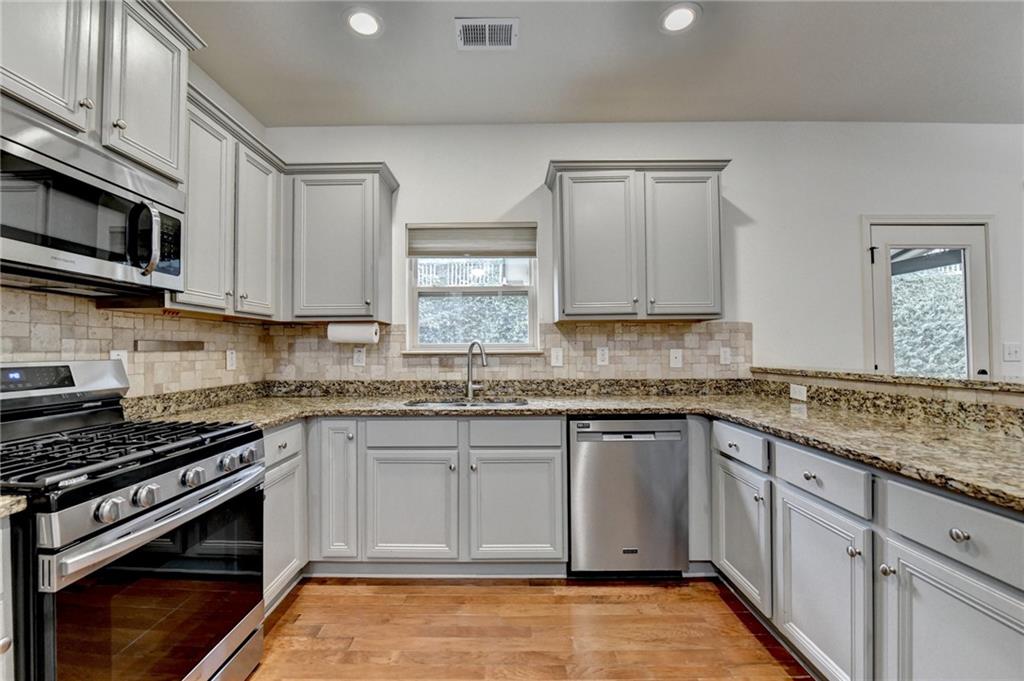 5013 Groover Drive Smyrna, GA 30080 - Photo 19 of 70 a kitchen with stainless steel appliances granite countertop a stove and a sink