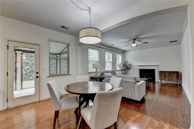 a view of a dining room with furniture wooden floor and chandelier