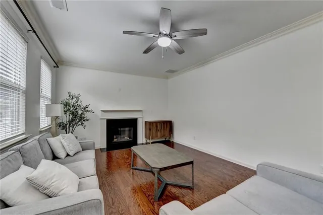 a view of a hallway with wooden floor and door