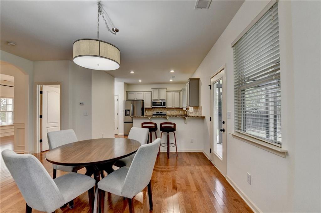 5013 Groover Drive Smyrna, GA 30080 - Photo 33 of 70 a view of a dining room with furniture wooden floor and chandelier