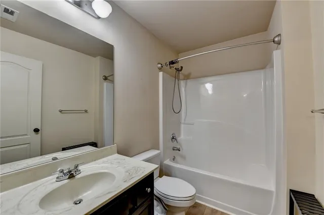 a bathroom with a double vanity sink a vanity and a large mirror