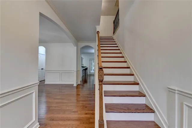 a view of entryway and hall with wooden floor