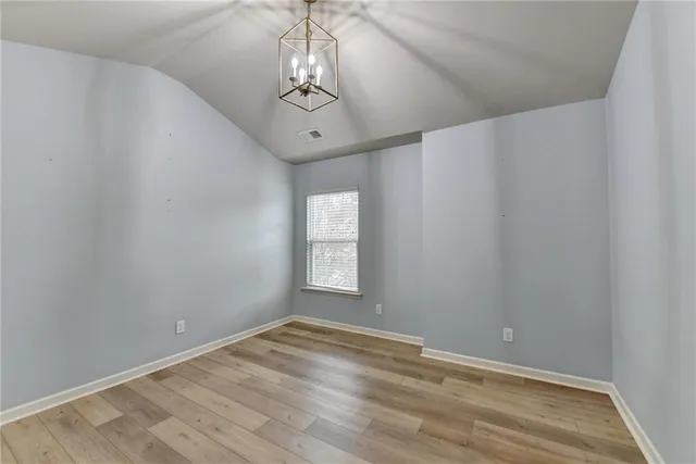 a living room with hardwood floor and sliding glass door