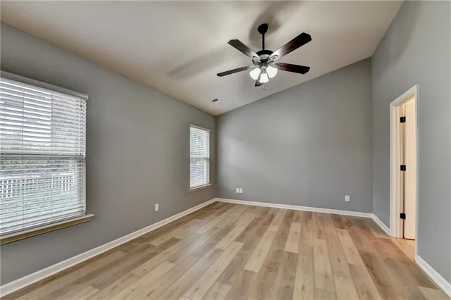 a view of a house with brick walls and a yard with plants