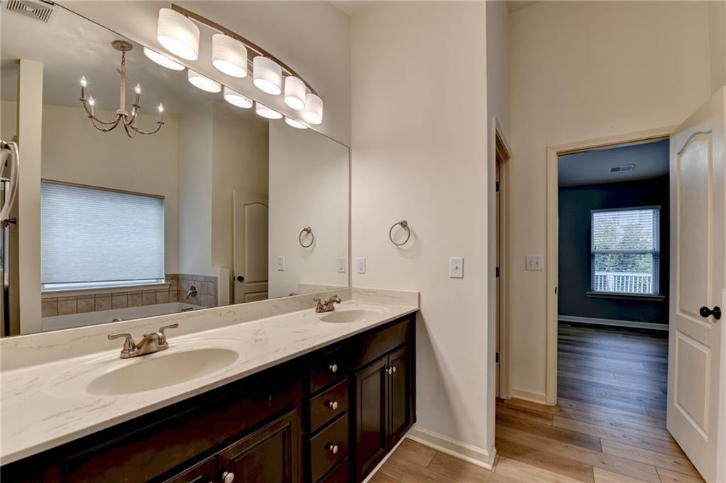 5013 Groover Drive Smyrna, GA 30080 - Photo 58 of 70 a bathroom with a double vanity sink a vanity and a large mirror