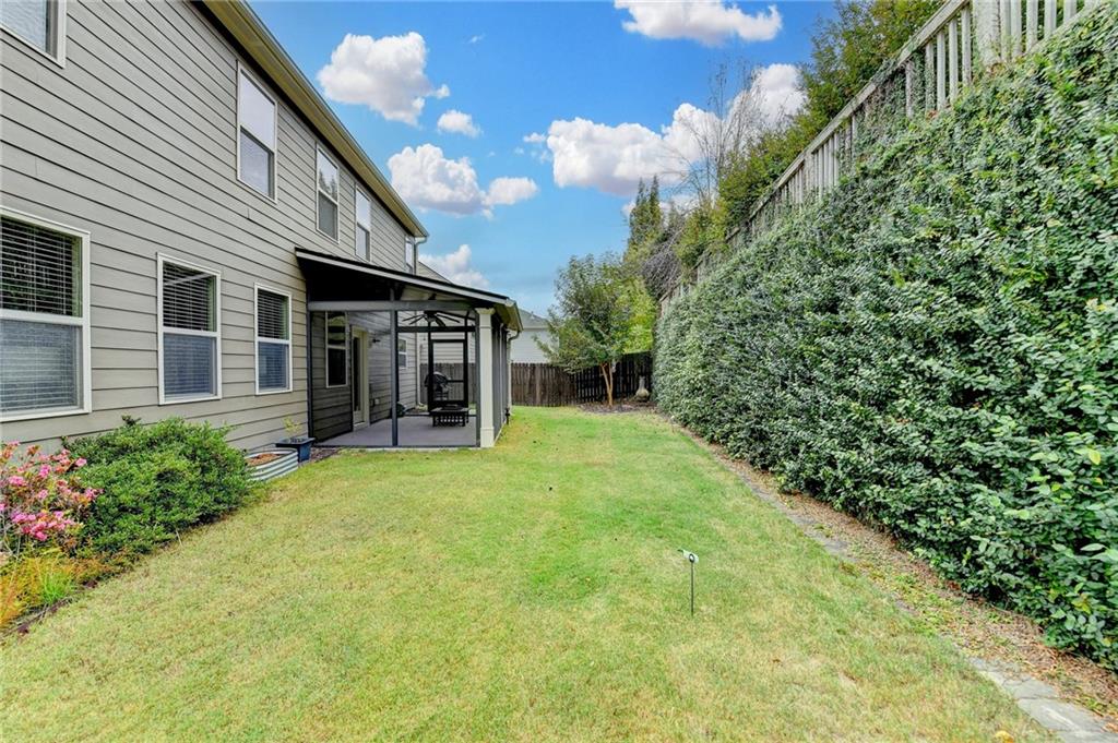 5013 Groover Drive Smyrna, GA 30080 - Photo 70 of 70 a view of a house with brick walls and a yard with plants