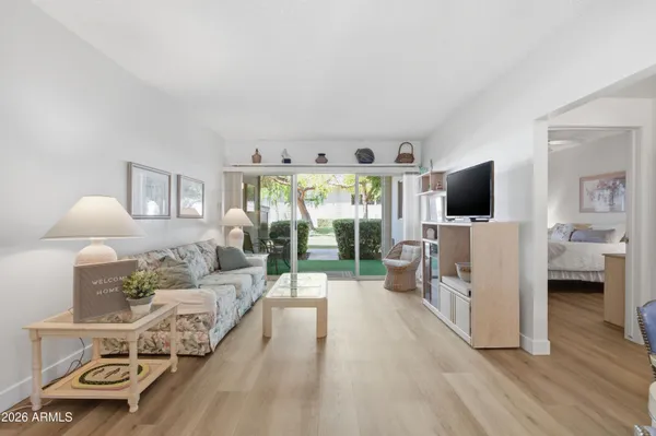 a spacious bedroom with a bed and a flat screen tv