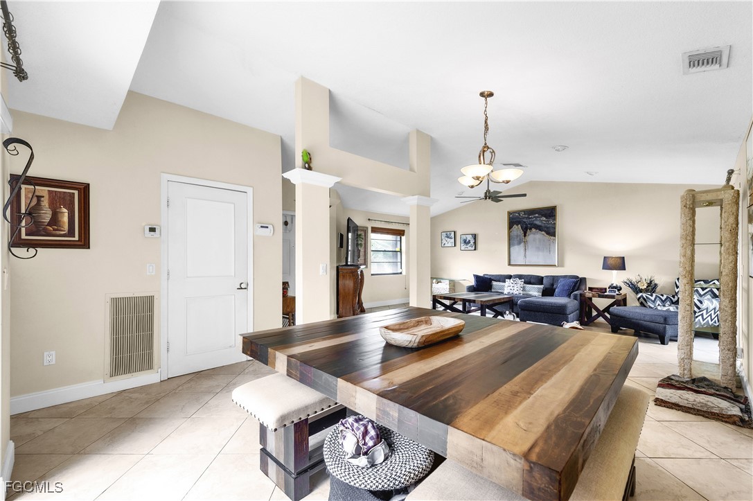 9141 Southwest 22nd Street, Unit F Boca Raton, FL 33428 - Photo 12 of 30 a living room with furniture and a chandelier