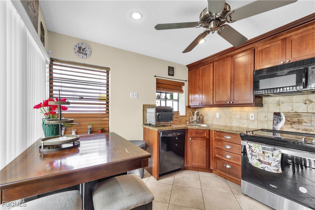9141 Southwest 22nd Street, Unit F Boca Raton, FL 33428 - Photo 13 of 30 a kitchen with granite countertop a sink cabinets and window